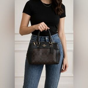 Coach Signature stylish dark brown bag with black accents